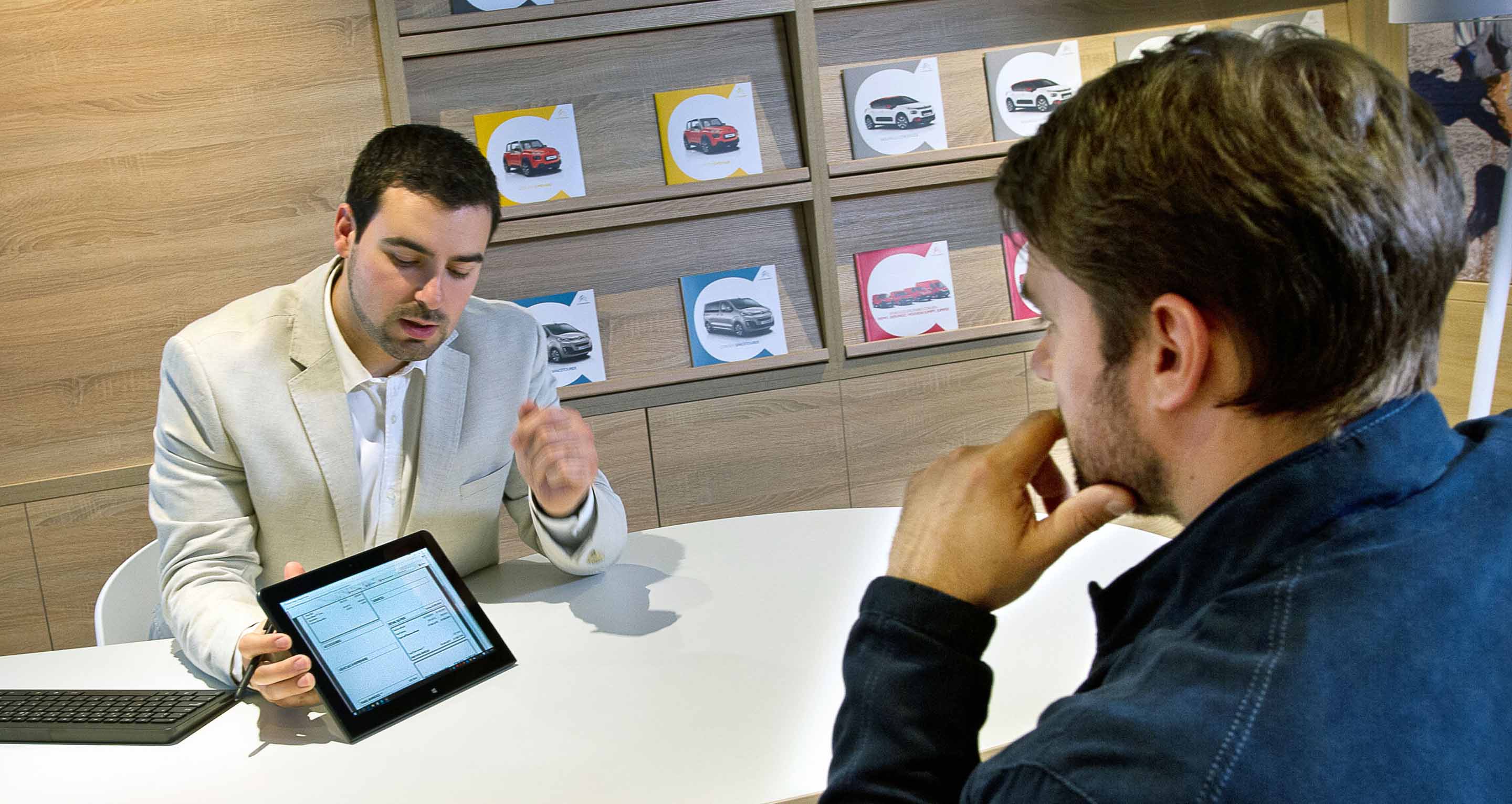 sales person with a customer in a dealership